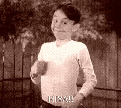 A Black And White Photo Of A Young Boy Saying Hiya ! GIF