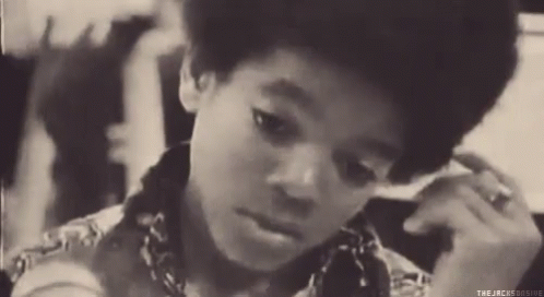 A Black And White Photo Of A Young Boy With The Words " The Jacksonsogive " On The Bottom Right GIF