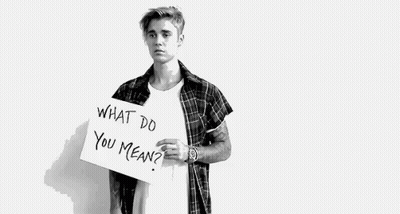 A Black And White Photo Of A Young Man Holding A Sign That Says `` What Do You Mean '' . GIF
