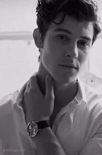 A Black And White Photo Of A Young Man In A White Shirt And A Watch . GIF