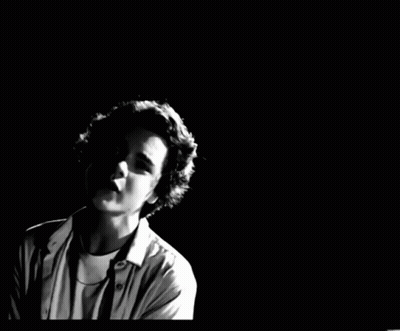 A Black And White Photo Of A Young Man GIF