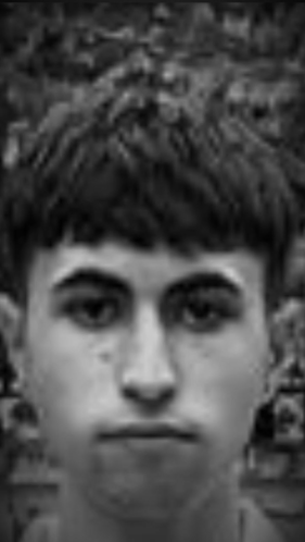 A Black And White Photo Of A Young Man Looking At The Camera . GIF