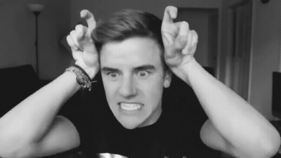 A Black And White Photo Of A Young Man Making A Face GIF