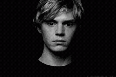 A Black And White Photo Of A Young Man 'S Face With A Serious Look On His Face . GIF