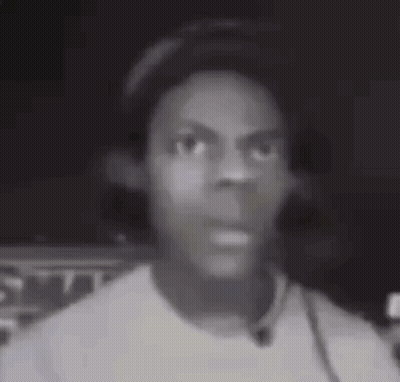A Black And White Photo Of A Young Man Wearing Headphones And A Hat . GIF