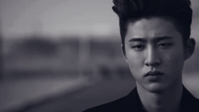 A Black And White Photo Of A Young Man With A Mohawk GIF