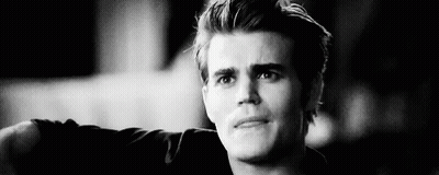 A Black And White Photo Of A Young Man With His Arm Outstretched . GIF