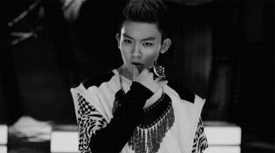 A Black And White Photo Of A Young Man With His Finger On His Lips . GIF