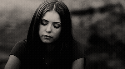 A Black And White Photo Of A Young Woman With Her Eyes Closed . GIF