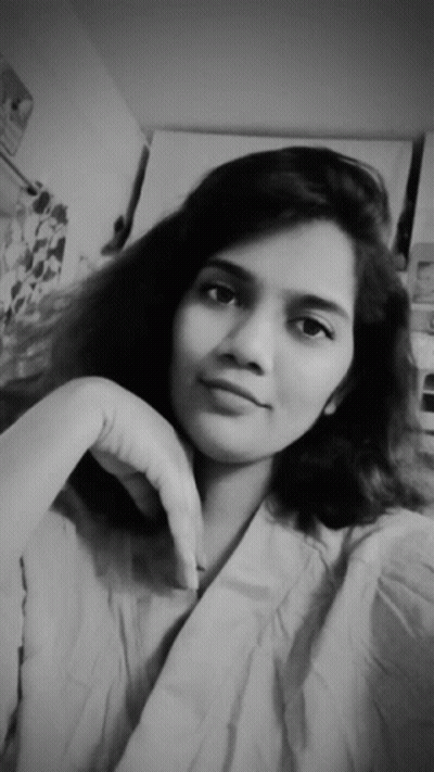 A Black And White Photo Of A Young Woman With Her Hand On Her Chin GIF