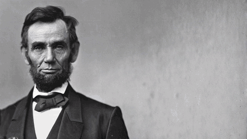 A Black And White Photo Of Abraham Lincoln With The Words " Do A Cor Look Si " Written On The Wall Behind Him GIF