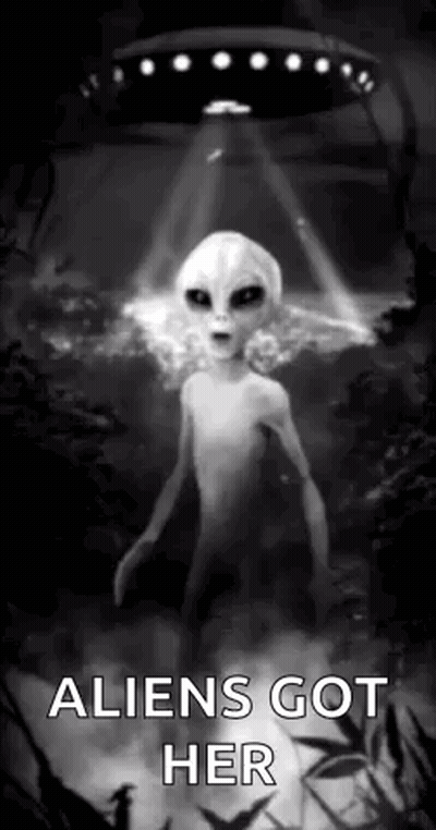 A Black And White Photo Of An Alien Standing In Front Of A Flying Saucer . GIF