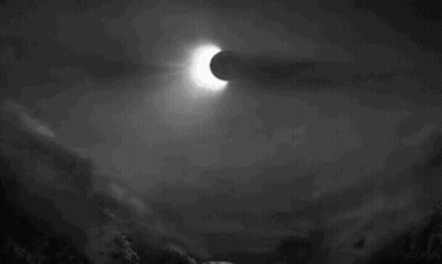 A Black And White Photo Of An Eclipse In The Night Sky GIF