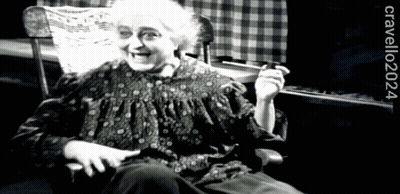 A Black And White Photo Of An Elderly Woman Sitting In A Rocking Chair With The Year 2024 On The Bottom GIF