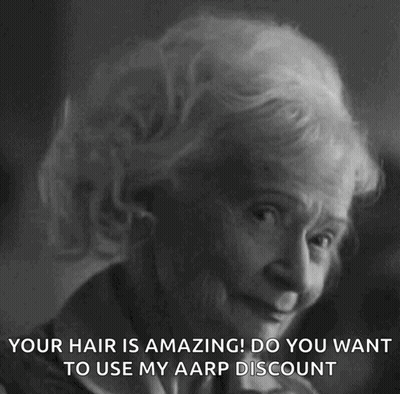 A Black And White Photo Of An Elderly Woman With The Caption " Your Hair Is Amazing ! Do You Want To Use My Aarp Discoun GIF