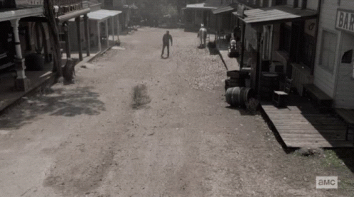 A Black And White Photo Of An Old Western Town With A Sign That Says ' A & M ' GIF