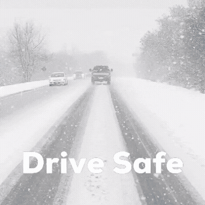 A Black And White Photo Of Cars Driving Down A Snowy Road GIF