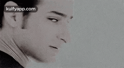 A Black And White Photo Of Elvis Presley 'S Face With A White Background . GIF
