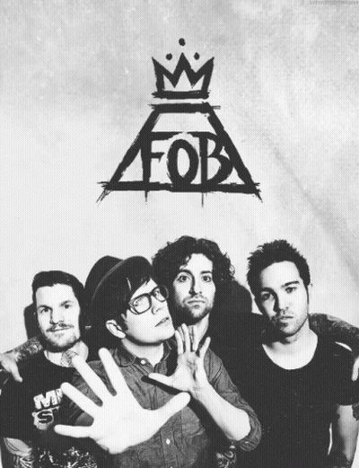 A Black And White Photo Of Four Men With A Fob Logo Behind Them GIF