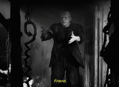 A Black And White Photo Of Frankenstein Holding A Snake With The Words Friend Below Him GIF