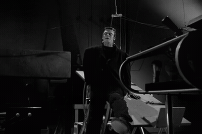 A Black And White Photo Of Frankenstein In A Dark Room GIF