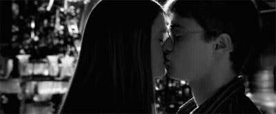 A Black And White Photo Of Harry Potter Andginny Weasley Kissing . GIF