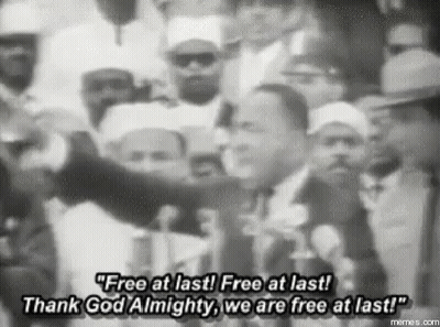A Black And White Photo Of Martin Luther King Jr. Speaking In Front Of A Crowd . GIF