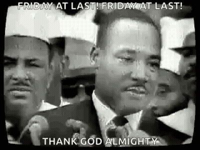 A Black And White Photo Of Martin Luther King Jr. Speaking Into A Microphone In Front Of A Crowd Of People . GIF