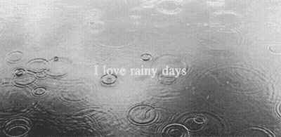 A Black And White Photo Of Rain Drops On A Body Of Water With The Words `` I Love Rainy Days '' GIF