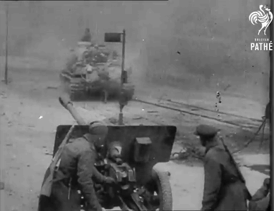 A Black And White Photo Of Soldiers And A Tank Taken By The Pathe GIF