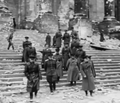 A Black And White Photo Of Soldiers Walking Down A Set Of Stairs GIF