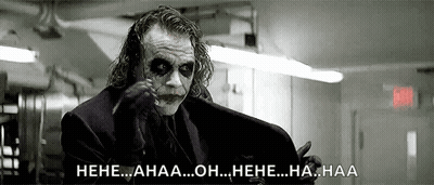 A Black And White Photo Of The Joker From The Movie The Dark Knight Rises Laughing . GIF