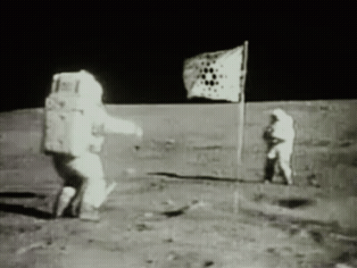 A Black And White Photo Of Two Astronauts On The Moon With A Flag In The Background GIF