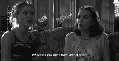 A Black And White Photo Of Two Girls Sitting On A Couch With One Saying " Where Did You Come From Planet Loser " GIF
