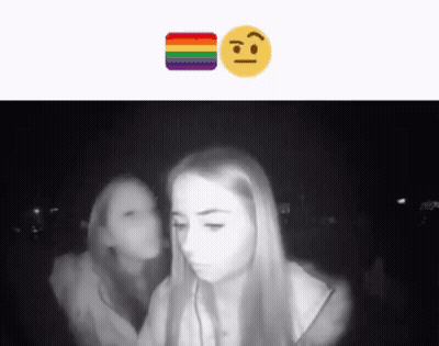 A Black And White Photo Of Two Girls With A Rainbow Smiley Face GIF