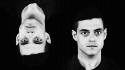 A Black And White Photo Of Two Men 'S Faces One Is Upside Down GIF