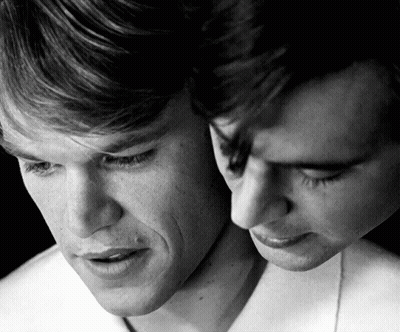 A Black And White Photo Of Two Men 'S Faces With Their Eyes Closed GIF