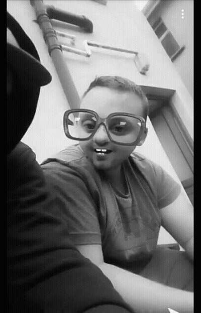 A Black And White Photo Of Two People Wearing Sunglasses GIF
