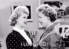 A Black And White Photo Of Two Women Hugging Each Other And Saying I Love You . GIF