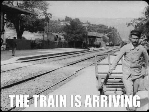 Black And White Photo Of Arriving Train GIF