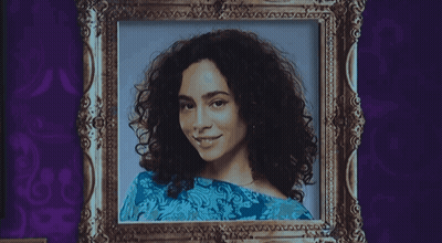 A Black And White Portrait Of A Woman With Curly Hair GIF