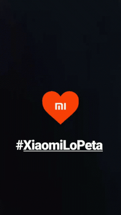 A Black Background With An Orange Heart With The Mi Logo On It GIF