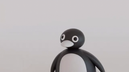 A Black Ball With White Eyes And A Red Nose GIF