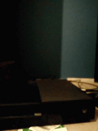 A Black Box Is Sitting On A Table In The Dark . GIF