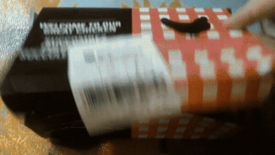 A Black Box With A Red And White Checkered Pattern Has The Word " Weapons " On It GIF