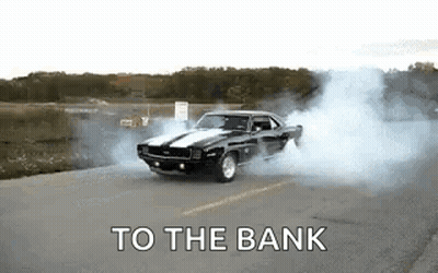 A Black Car Is Drifting Down A Road With Smoke Coming Out Of Its Tires . GIF