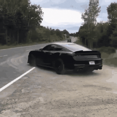A Black Car Is Driving Down A Road With A License Plate That Says ' A ' On It GIF