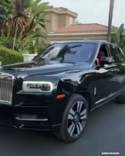 A Black Car Is Parked In Front Of A House GIF