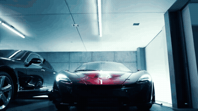 A Black Car Is Parked Next To A Red Sports Car GIF
