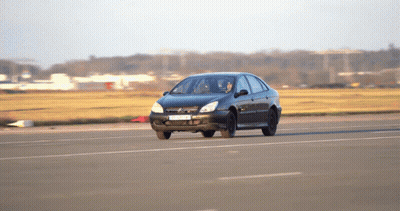A Black Car With A License Plate That Says ' A ' On It Drives Down A Road GIF